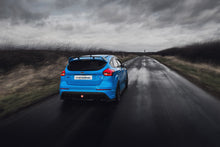 Load image into Gallery viewer, The image shows a blue Ford Focus RS MK3 dirivinf down a country road during stormy weather.